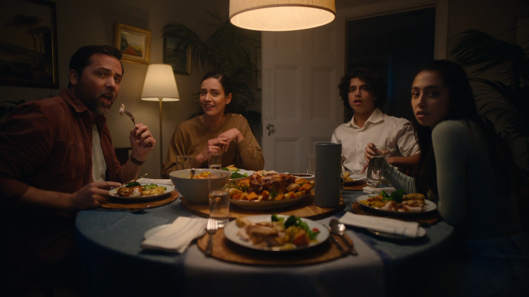 A family frozen at the dinner table